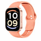 A smartwatch with a peach-colored silicone band and a rose gold metallic case, shown on a plain white background. The watch face is on and displaying a digital clock interface.