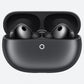 Black true wireless earbuds in an open charging case on a light gray background.