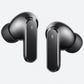 A pair of dark gray wireless earbuds with glossy metallic finishes, shown floating against a solid light gray background.
